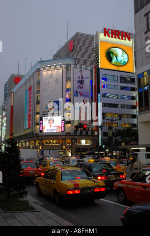 Traffic and Neon Lights on Ginza Shopping District in Tokyo Japan Stock Photo