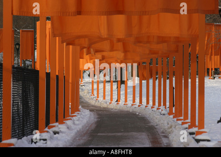 Suffron coloured gates forming a tunnel over a footpath in the Central of New York.  Christo and Jeanne-Claude Stock Photo