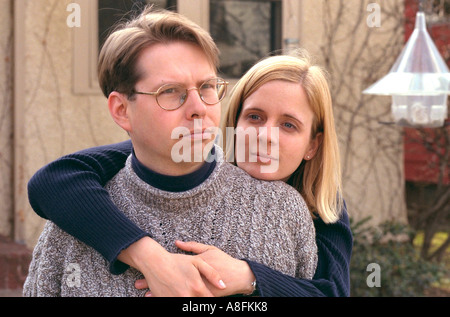 Portrait of a dreamy wife holding her husband age 30. St Paul Minnesota USA Stock Photo