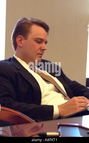 Portrait of a thoughtful business man wearing a suit working at his desk age 32. St Paul Minnesota USA Stock Photo