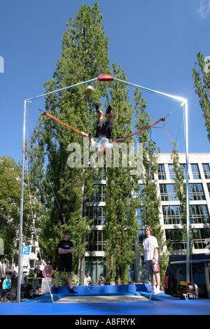 Girl bouncing on Trampoline with bungee jumping Stock Photo