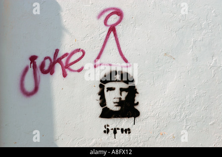 Graffiti and a stencil of revolutionary legend Ernesto Che Guevara coexist on a wall of Oaxaca Mexico Stock Photo
