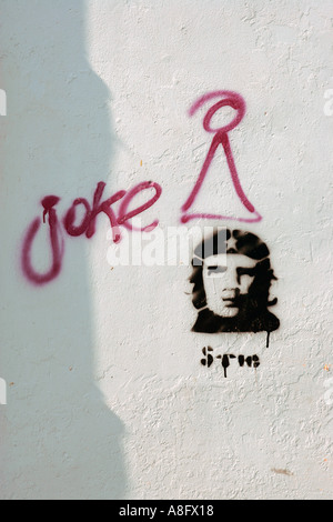 Graffiti and a stencil of revolutionary legend Ernesto Che Guevara coexist on a wall of Oaxaca Mexico Stock Photo