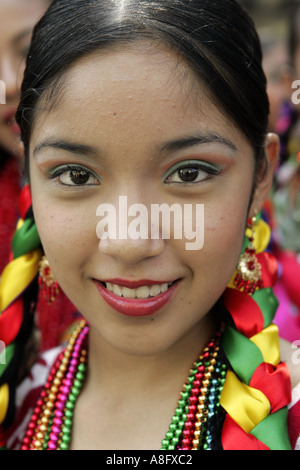 A teenager in local traditional costume poses for a photo before the beginning of a parade in Oaxaca Mexico Stock Photo