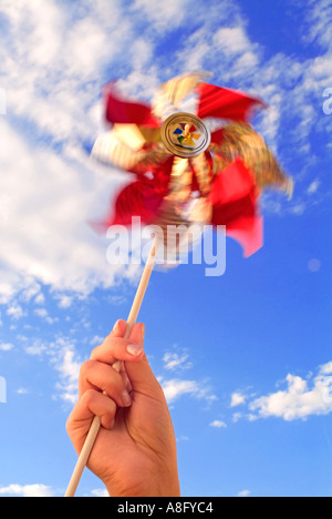 Pinwheel Hand Hand holding colorful toy pinwheel on white background Stock Photo - Alamy