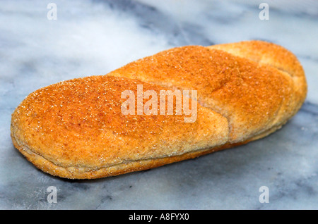 A wholemeal submarine roll on a marble background Stock Photo