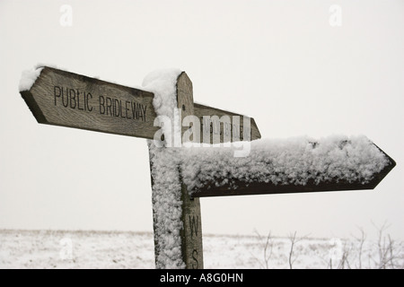 Snow on a footpath sign. Stock Photo