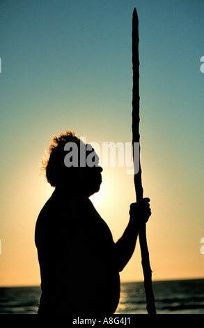 aboriginal with walking stick gazing at the sea, Darwin, Australia Stock Photo