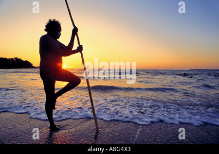 aboriginal with wooden stick gazing at the sea, Darwin, Australia Stock Photo