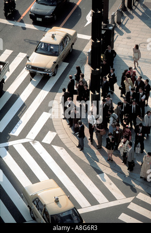 people and businessmen on pedestrian crossing in intersection, Ginza, Tokyo, Japan Stock Photo