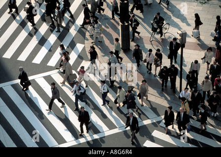 people and businessmen on pedestrian crossing in intersection, Ginza, Tokyo, Japan Stock Photo