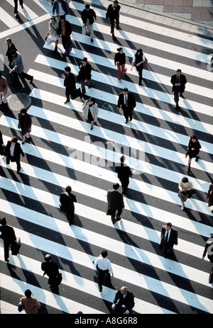 people and businessmen on pedestrian crossing in intersection, Ginza, Tokyo, Japan Stock Photo