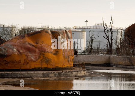 Damaged oil tank and charred trees, Buncefield depot, Hemel Hempstead, Hertfordshire, UK Stock Photo