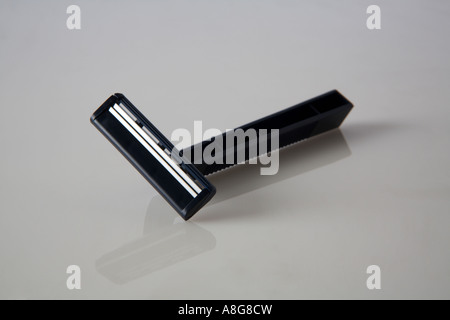 disposable dark blue razor lying on back from a side view on a white back ground Stock Photo