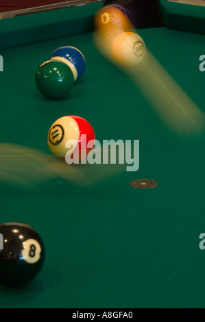 Pool balls in motion on table Stock Photo