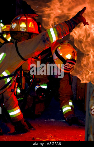 Firefighters and people fighting a fire inside a workshop in Pudahuel ...