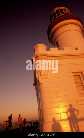 Cape Byron lighthouse at dusk with shadows of people on its exterior Byron Bay New South Wales Australia Stock Photo