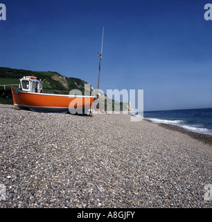 Orange boat on pebble beach Stock Photo - Alamy
