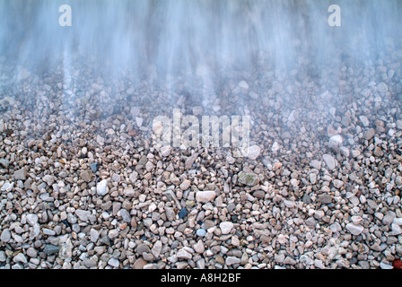 Ocean Waves Lapping the Pebble Covered Sea Shore Stock Photo