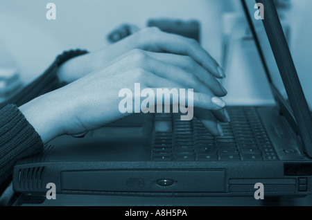 Woman s hands using laptop close up Stock Photo