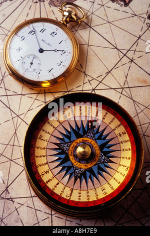 Compass and old pocket watch on old map Stock Photo