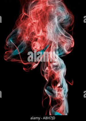 Colorized incense smoke trails on a black background Stock Photo