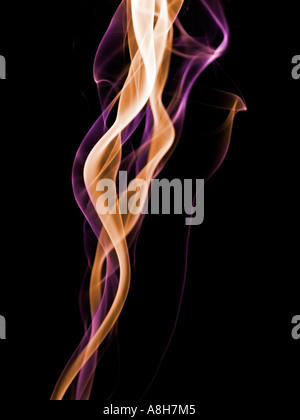 Colorized incense smoke trails on a black background Stock Photo