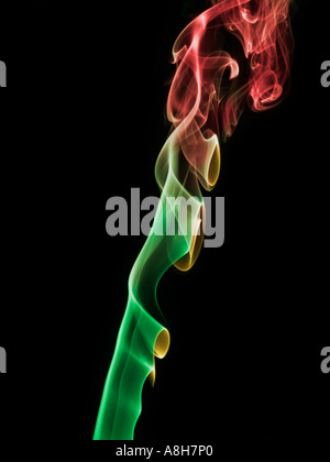 Colorized incense smoke trails on a black background Stock Photo
