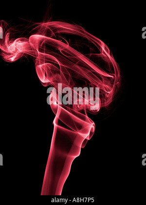 Colorized incense smoke trails on a black background Stock Photo