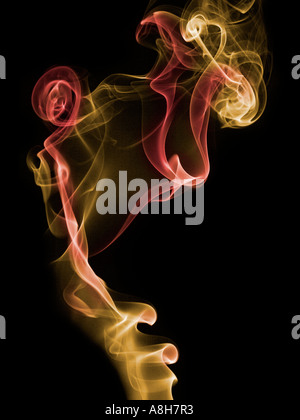 Colorized incense smoke trails on a black background Stock Photo