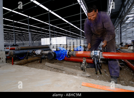 Men at work in the Greenhouses place Westland Zuid Holland pipe fitter blur Stock Photo