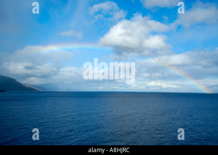Rainbow and clouds over the sea Lofoten Norway Stock Photo