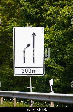 German autobahn road sign warning of merging traffic lanes ahead Germany Europe Stock Photo