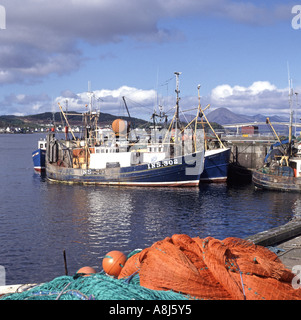 Loch Alsh Kyle Of Lochalsh harbour with fishing boat & nets Kyleakin village & one time toll bridge road on Isle of Skye beyond Highland Scotland UK Stock Photo