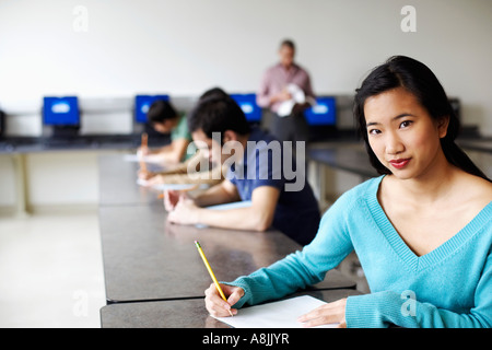 Portrait of a young woman giving exams in a classroom