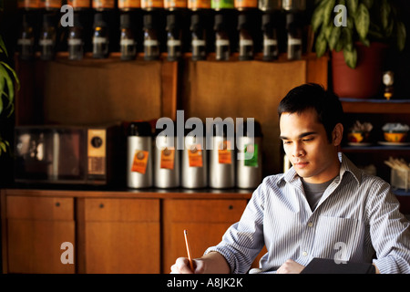 Young man writing with a pencil Stock Photo