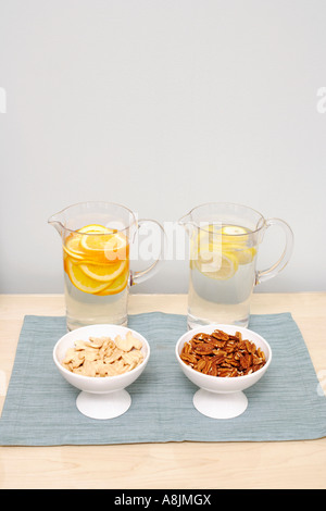 Jugs of fresh refreshing fruit drinks with fruit wedges summer cold