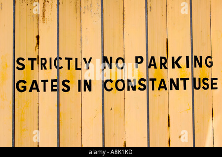 strictly no parking gates in constant use sign Stock Photo