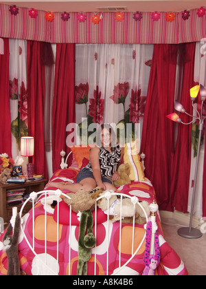 Young 4 year old girl in child's bedroom with brass bed showing