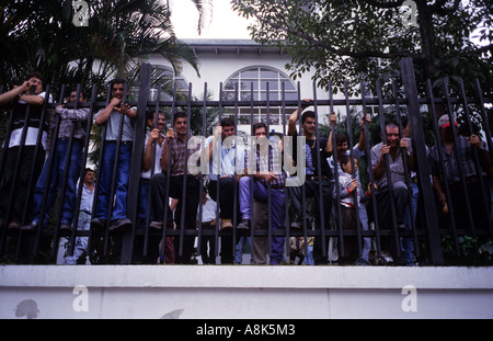 Nicaraguans wait at the Nicaraguan embassy in San Jose, Costa Rica to receive permission to work in Costa Rica. Stock Photo