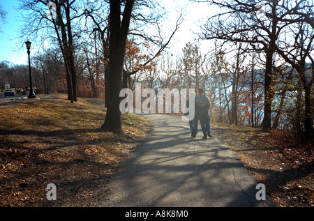 Couple age 21 soaking up the beauty of an autumn walk overlooking the Mississippi River. St Paul Minnesota USA Stock Photo