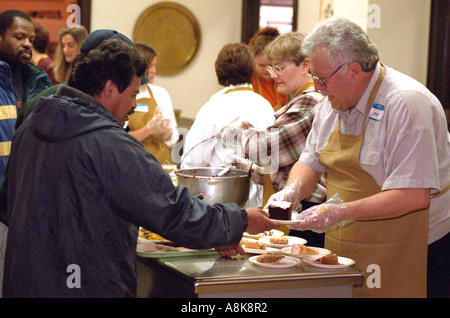 Volunteers serving Exchange Charities Thanksgiving soup kitchen dinner. Minneapolis Minnesota USA Stock Photo