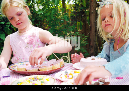 Children decorating cakes Stock Photo