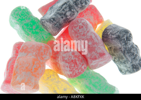 Horizontal close up of a pile of powdery multi coloured jelly babies on a white background Stock Photo