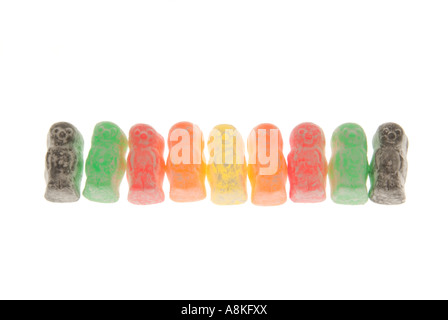 Horizontal close up of a row of multi coloured jelly babies on a white background. Stock Photo