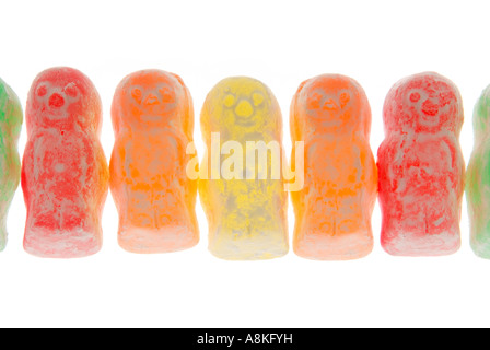 Horizontal close up of a row of multi coloured jelly babies on a white background. Stock Photo