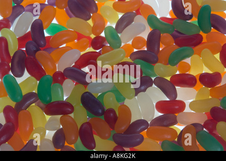 Horizontal close up of lots of identical multi coloured jelly beans. Stock Photo
