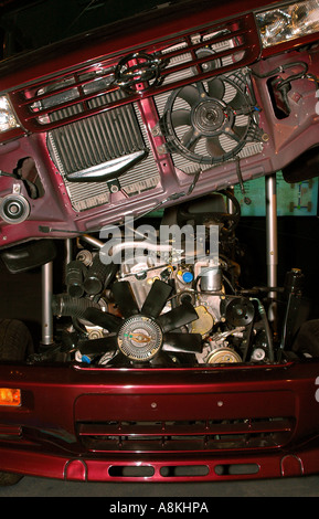 A cutaway view of a vehicle, highlighting the integration of the car's engine, cooling system, and front body assembly. Stock Photo