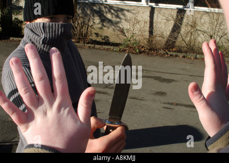 Juvenile delinquency, robbery, attack, knife, avert Stock Photo