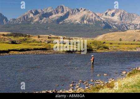 IDAHO SAWTOOTH MOUNTAINS Fly fisherman casting for rainbow trout on the Main Salmon River Stanley Id Stock Photo